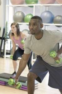 man and women exercising in gym