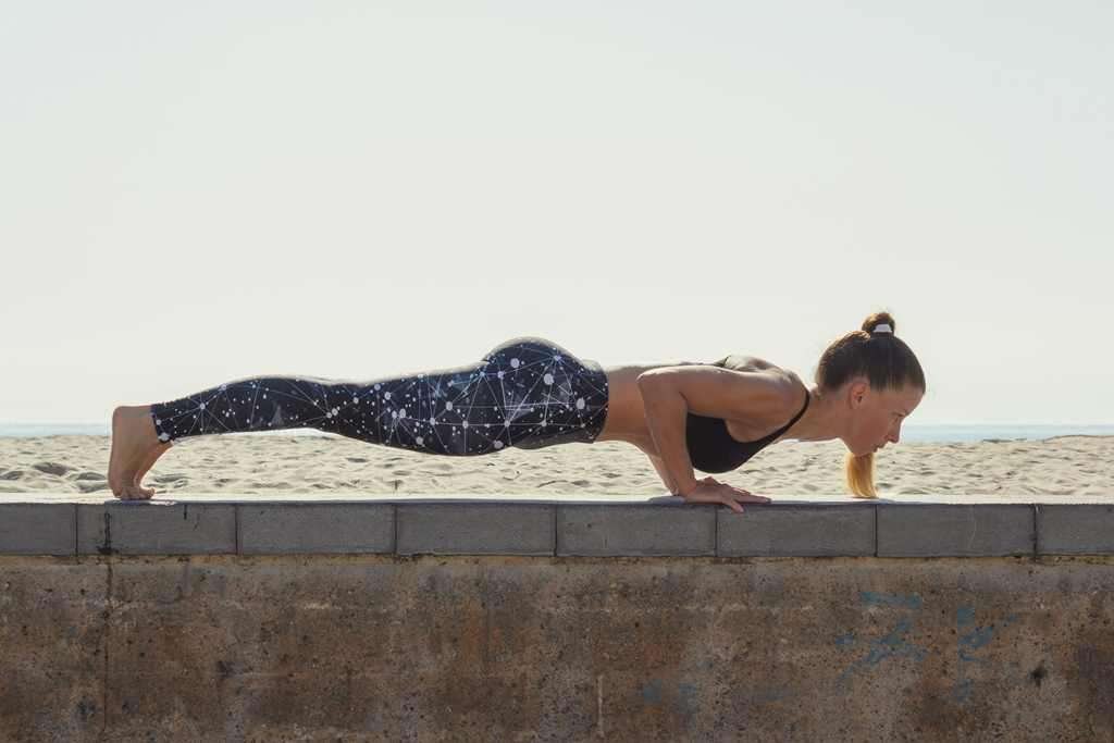 fit girl in plank/push up position